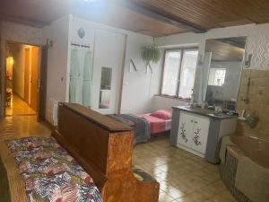 a room with two beds and a sink and a bathroom at L'Escapade de JOS , chambres et table d'hôte in Pont-de-Salars