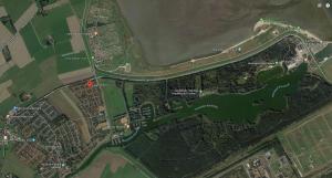 a map of a park with a road and a river at Nordlys in Hooksiel +5 photos