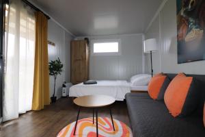 a living room with a couch and a bed at Kemp Děčín in Děčín