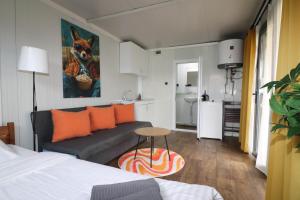 a room with a couch and a table and a kitchen at Kemp Děčín in Děčín