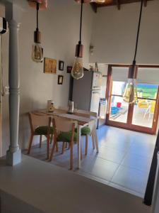 a kitchen with a table and chairs with a view of the ocean at BAHIA BLANCA-BARRIO PARQUE in Bahía Blanca