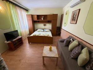a living room with a couch and a bed at Fran in Crikvenica