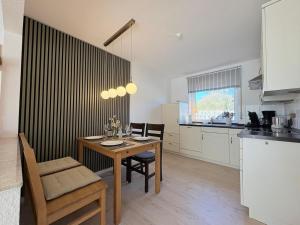 a kitchen and dining room with a table and chairs at Haus Strandgut in Hooksiel in Wangerland
