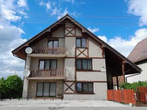 a building with a balcony on the side of it at Privat Severka in Pavčina Lehota