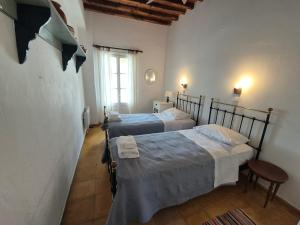 a bedroom with two beds and a window at House in Kamares - Sifnos in Kamares