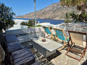 a group of chairs and a bench and a table at House in Kamares - Sifnos in Kamares