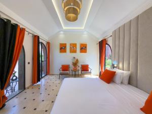 a bedroom with a large bed with orange accents at Just V hotel & Spa in Marrakesh +199 photos