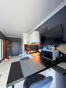 a kitchen with a table with a microwave on it at RVR Apartmanhàz in Sárospatak