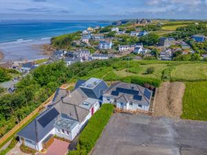 an aerial view of a house on a hill next to the ocean at Heddfan Cottage in Haverfordwest