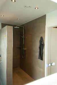 a bathroom with a shower with a glass door at Haus Wanger Meerblick in Wangerland +16 photos