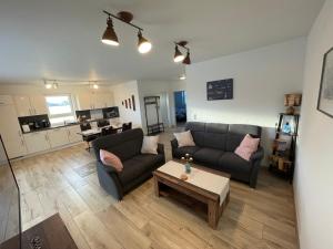 a living room with a couch and a coffee table at Wangerkajüte in Wangerland
