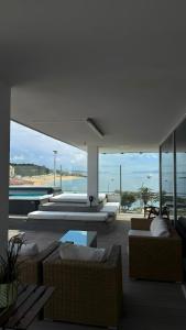 a living room with couches and a swimming pool at Casa do Mar Oeiras in Oeiras