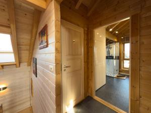 a hallway in a log cabin with a door at Haus Sina in Wangerland +59 photos