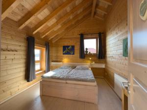 a bedroom with a bed in a wooden cabin at Haus Sina in Wangerland