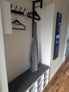 a dressing room with a shelf and a mirror at Hausboot MeerZeit in Wangerland