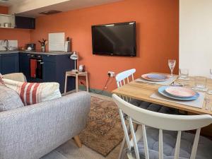 a living room with a couch and a table at Bay Tree in Sturminster Newton