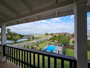 a view of the pool from the balcony of a resort at 28 Kabeljauws in Jeffreys Bay
