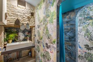a bathroom with a sink and a shower at La Grange des zarts in Champagné-le-Sec +23 photos