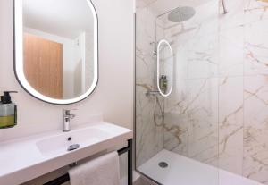 a bathroom with a sink and a shower at B&B HOTEL Lille Roubaix Centre Grand-Place in Roubaix