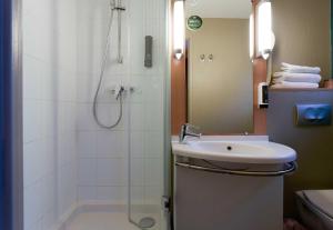 a bathroom with a shower and a sink and a shower at B&B HOTEL Reims Centre Erlon in Reims
