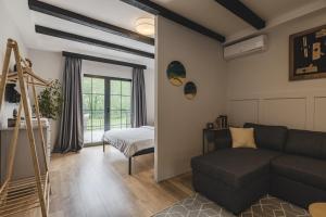 a living room with a couch and a bed at Kami The Essence in Danilovgrad