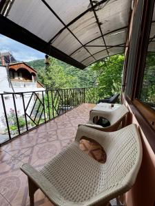 a balcony with two white chairs and a window at IRIS B&B in DEBED CANYON in Alaverdi