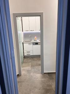 a kitchen with a sink and a mirror at Centrum Apartman LEYLA 8 in Bardejov +8 photos