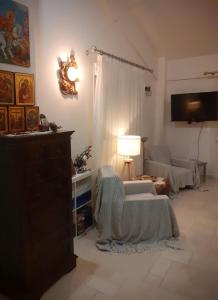 a living room with a couch and a table at ELENI'S HOUSE FOR VACATION in Nea Plagia