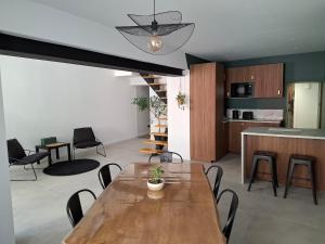 a living room with a wooden table and chairs at Les 3 suites in Issoire