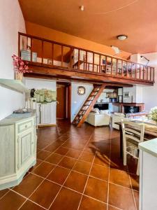 a kitchen and living room with a loft at Amazing house 10 minutes by car from the beach in Olbia +10 photos