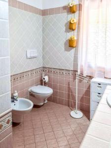 a bathroom with a toilet and a sink at Amazing house 10 minutes by car from the beach in Olbia