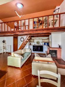 a living room filled with furniture and a staircase at Amazing house 10 minutes by car from the beach in Olbia