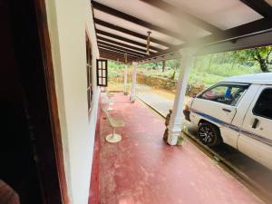 a white car parked in a garage next to a carport at Green views in Norton Bridge