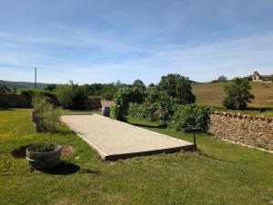 a path in a yard with a stone wall at Maison Mazille in Mazille +4 photos