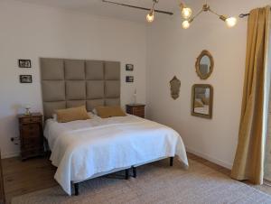 a bedroom with a large bed with a large headboard at Maison Mazille in Mazille