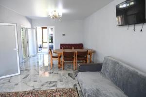 a living room with a dining room table and chairs at Oasis in Edineţ