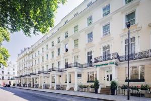 a row of white buildings on a street at Park Avenue Bayswater Inn Hyde Park in London
