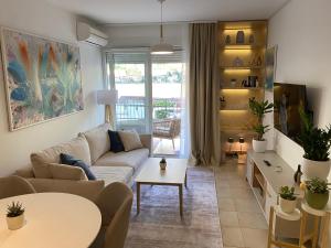 a living room with a couch and a table at Kotor Bay View Residence with Pool in Muo