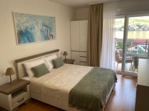 a bedroom with a bed and a balcony at Kotor Bay View Residence with Pool in Muo
