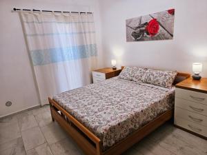 a small bedroom with a bed and a window at Villa Sole in San Giovanni