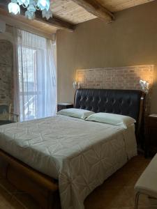 a bedroom with a large bed with a large window at B&B Casa CamiLory in San Lucido +104 photos