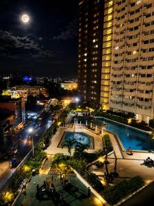 a view of a city at night with a pool at The Nook at Avida Towers 2 CDO in Cagayan de Oro