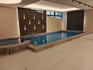 a large swimming pool in a building at Voyage Expo Suites in Riyadh