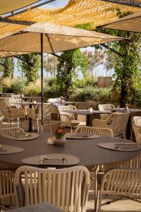 a table with chairs and an umbrella on a patio at Savoia Hotel Rimini in Rimini +98 photos