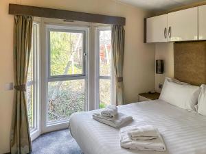 a bedroom with a bed and a large window at Toucana - Uk49468 in Morpeth