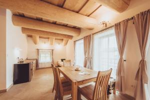a dining room with a wooden table and chairs at Ranč Telč in Telč