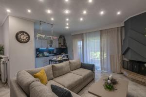 a living room with a couch and a table at Elissavet Maison in Perea