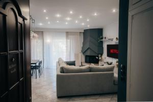 a living room with a couch and a table at Elissavet Maison in Perea