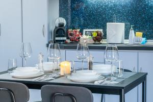 a table with plates and wine glasses on it at Elissavet Maison in Perea +34 photos