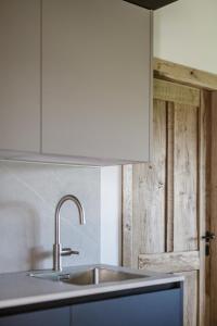 a kitchen with a sink and a white cabinet at Arriola Txiki in Itziar